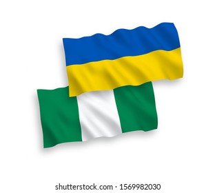 National vector fabric wave flags of Nigeria and Ukraine isolated on white background. 1 to 2 proportion.