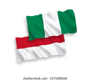 National vector fabric wave flags of Indonesia and Nigeria isolated on white background. 1 to 2 proportion.