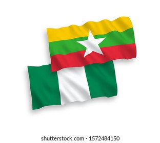 National vector fabric wave flags of Nigeria and Myanmar isolated on white background. 1 to 2 proportion.