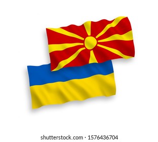 National vector fabric wave flags of North Macedonia and Ukraine isolated on white background. 1 to 2 proportion.