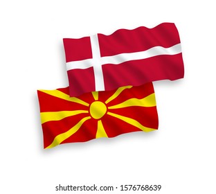 National vector fabric wave flags of Denmark and North Macedonia isolated on white background. 1 to 2 proportion.