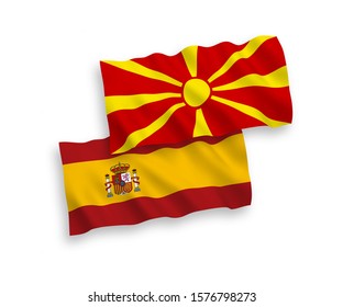 National vector fabric wave flags of North Macedonia and Spain isolated on white background. 1 to 2 proportion.