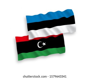 National vector fabric wave flags of Estonia and Libya isolated on white background. 1 to 2 proportion.