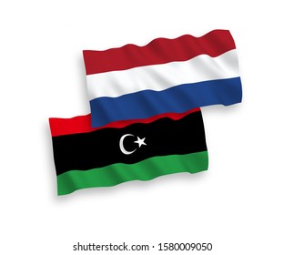National vector fabric wave flags of Libya and Netherlands isolated on white background. 1 to 2 proportion.