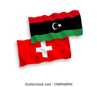 National vector fabric wave flags of Libya and Switzerland isolated on white background. 1 to 2 proportion.