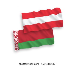 National vector fabric wave flags of Austria and Belarus isolated on white background. 1 to 2 proportion.