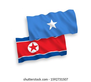 National vector fabric wave flags of North Korea and Somalia isolated on white background. 1 to 2 proportion.