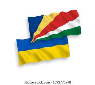 National vector fabric wave flags of Seychelles and Ukraine isolated on white background. 1 to 2 proportion.