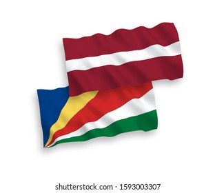 National vector fabric wave flags of Latvia and Seychelles isolated on white background. 1 to 2 proportion.