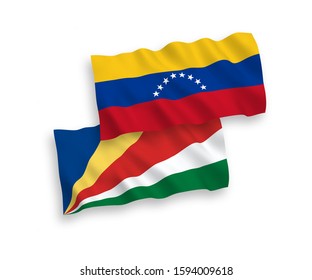 National vector fabric wave flags of Venezuela and Seychelles isolated on white background. 1 to 2 proportion.
