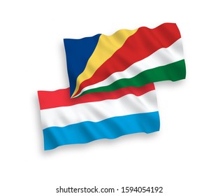 National vector fabric wave flags of Seychelles and Luxembourg isolated on white background. 1 to 2 proportion.