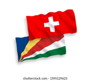 National vector fabric wave flags of Seychelles and Switzerland isolated on white background. 1 to 2 proportion.