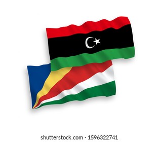 National vector fabric wave flags of Seychelles and Libya isolated on white background. 1 to 2 proportion.