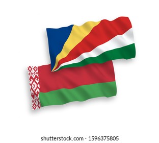 National vector fabric wave flags of Seychelles and Belarus isolated on white background. 1 to 2 proportion.