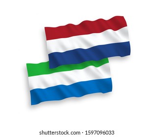 National vector fabric wave flags of Sierra Leone and Netherlands isolated on white background. 1 to 2 proportion.