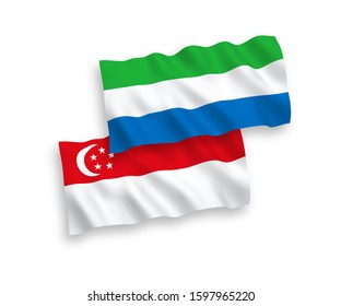 National vector fabric wave flags of Sierra Leone and Singapore isolated on white background. 1 to 2 proportion.