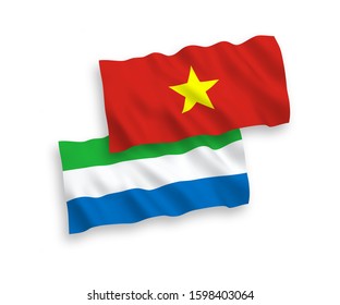 National vector fabric wave flags of Sierra Leone and Vietnam isolated on white background. 1 to 2 proportion.