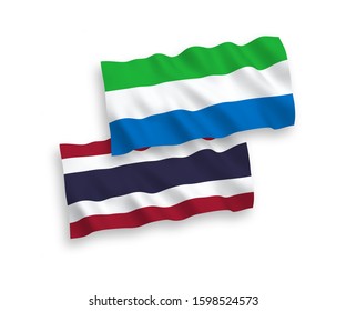 National vector fabric wave flags of Sierra Leone and Thailand isolated on white background. 1 to 2 proportion.