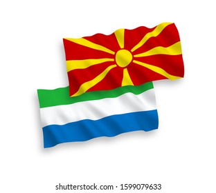 National vector fabric wave flags of Sierra Leone and North Macedonia isolated on white background. 1 to 2 proportion.