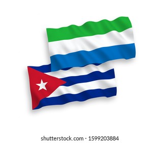National vector fabric wave flags of Sierra Leone and Cuba isolated on white background. 1 to 2 proportion.