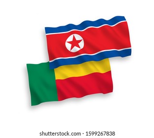 National vector fabric wave flags of North Korea and Benin isolated on white background. 1 to 2 proportion.