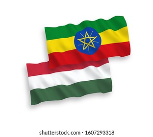 National vector fabric wave flags of Ethiopia and Hungary isolated on white background. 1 to 2 proportion.