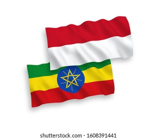 National vector fabric wave flags of Indonesia and Ethiopia isolated on white background. 1 to 2 proportion.