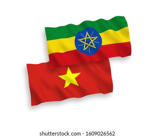National vector fabric wave flags of Ethiopia and Vietnam isolated on white background. 1 to 2 proportion.