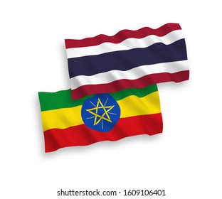 National vector fabric wave flags of Ethiopia and Thailand isolated on white background. 1 to 2 proportion.
