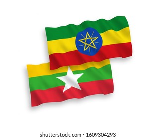 National vector fabric wave flags of Ethiopia and Myanmar isolated on white background. 1 to 2 proportion.