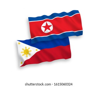 National vector fabric wave flags of North Korea and Philippines isolated on white background. 1 to 2 proportion.