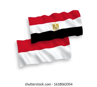 National vector fabric wave flags of Indonesia and Egypt isolated on white background. 1 to 2 proportion.