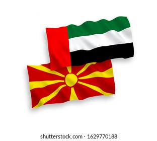 National vector fabric wave flags of United Arab Emirates and North Macedonia isolated on white background. 1 to 2 proportion.