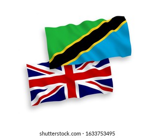 National vector fabric wave flags of Great Britain and Tanzania isolated on white background. 1 to 2 proportion.