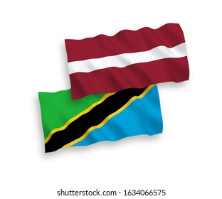 National vector fabric wave flags of Latvia and Tanzania isolated on white background. 1 to 2 proportion.