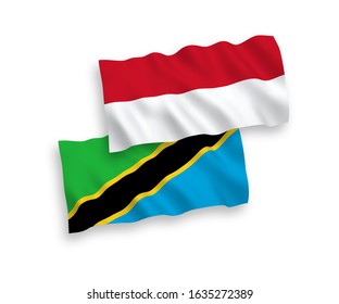 National vector fabric wave flags of Indonesia and Tanzania isolated on white background. 1 to 2 proportion.