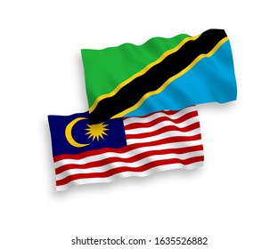 National vector fabric wave flags of Tanzania and Malaysia isolated on white background. 1 to 2 proportion.