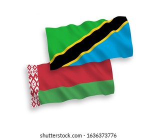 National vector fabric wave flags of Tanzania and Belarus isolated on white background. 1 to 2 proportion.