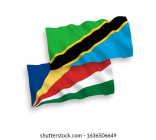 National vector fabric wave flags of Tanzania and Seychelles isolated on white background. 1 to 2 proportion.