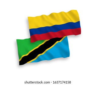 National vector fabric wave flags of Tanzania and Colombia isolated on white background. 1 to 2 proportion.