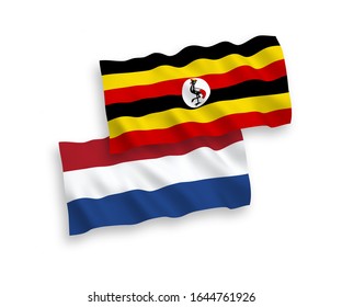 National vector fabric wave flags of Uganda and Netherlands isolated on white background. 1 to 2 proportion.