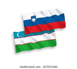 National vector fabric wave flags of Slovenia and Uzbekistan isolated on white background. 1 to 2 proportion.