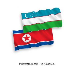 National vector fabric wave flags of North Korea and Uzbekistan isolated on white background. 1 to 2 proportion.