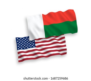 National vector fabric wave flags of Madagascar and USA isolated on white background. 1 to 2 proportion.