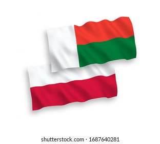 National vector fabric wave flags of Madagascar and Poland isolated on white background. 1 to 2 proportion.