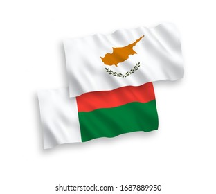 National vector fabric wave flags of Cyprus and Madagascar isolated on white background. 1 to 2 proportion.