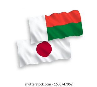 National vector fabric wave flags of Japan and Madagascar isolated on white background. 1 to 2 proportion.
