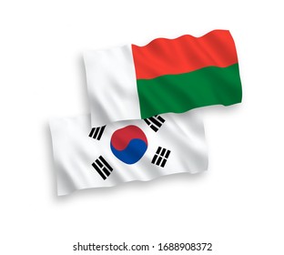 National vector fabric wave flags of South Korea and Madagascar isolated on white background. 1 to 2 proportion.