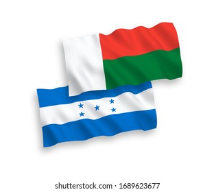 National vector fabric wave flags of Madagascar and Honduras isolated on white background. 1 to 2 proportion.