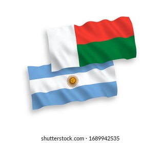 National vector fabric wave flags of Madagascar and Argentina isolated on white background. 1 to 2 proportion.